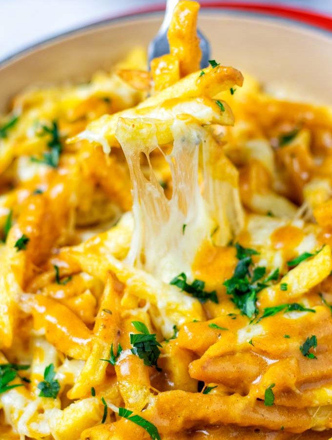 Disco Fries taken from the casserole dish with a fork.