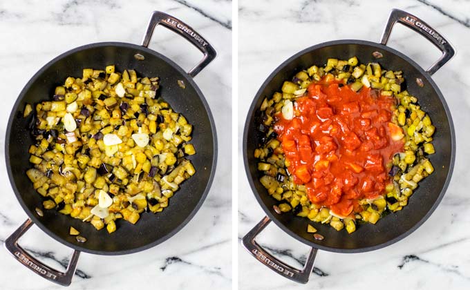 Saucepan with fried eggplant cubes and diced tomatoes given over them.