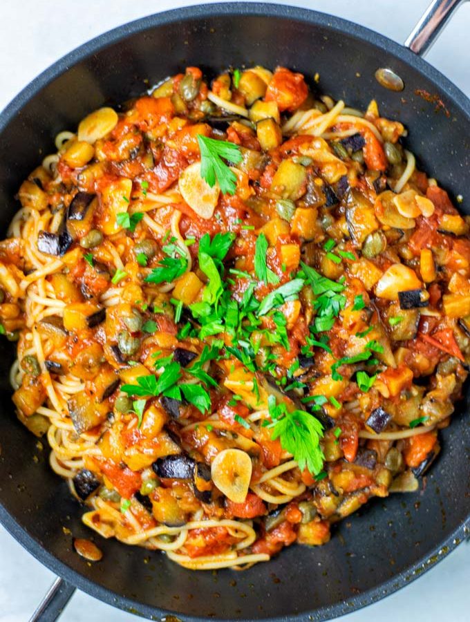 Top view of the Pasta alla Norma in a saucepan, garnished with parsley.