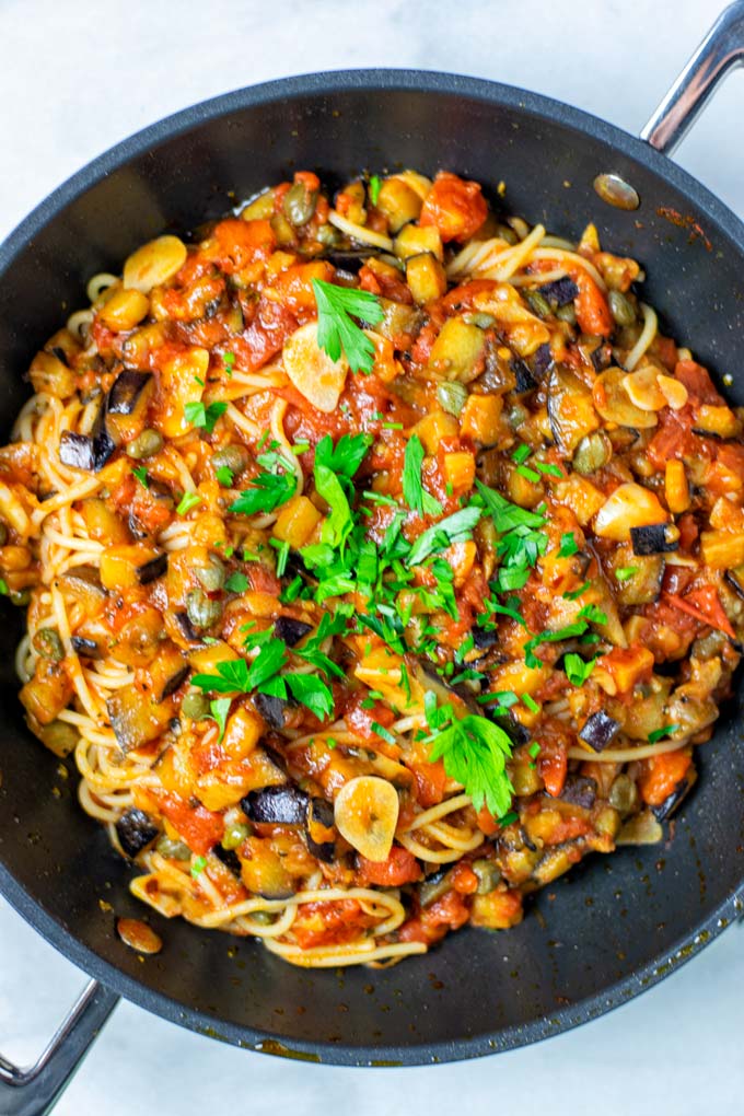 Top view of the Pasta alla Norma in a saucepan, garnished with parsley.