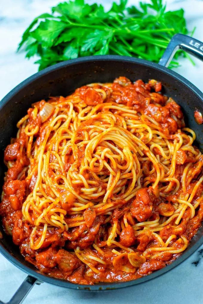 View on a sauce pan with Spaghetti Sauce mixed with cooked pasta.