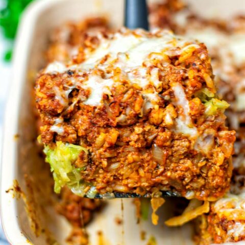 Closeup of a portion of the Cabbage Roll Casserole, lifted with a spoon out of the casserole dish.