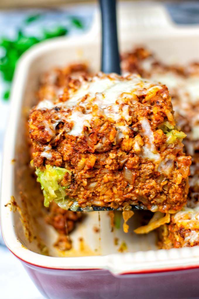 Closeup of a portion of the Cabbage Roll Casserole, lifted with a spoon out of the casserole dish.