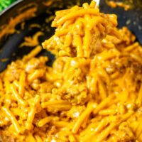 A large spoon of the Hamburger Helper is lifted from the pan.