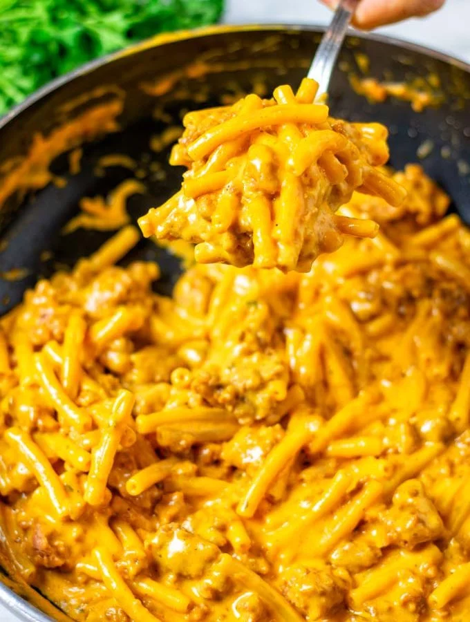 A large spoon of the Hamburger Helper is lifted from the pan.
