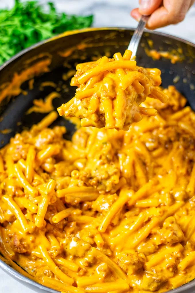 A large spoon of the Hamburger Helper is lifted from the pan.