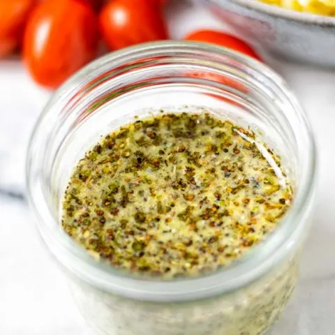 Closeup on the Italian Dressing in a glass jar.