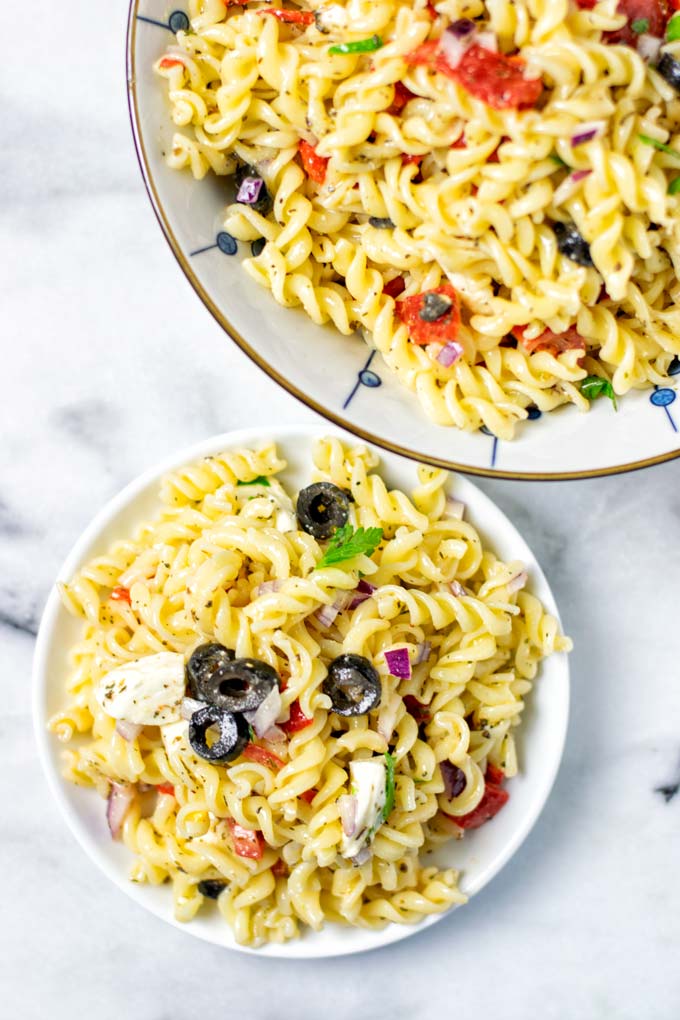 Top view on a portion of the Italian Pasta Salad and a serving bowl. 