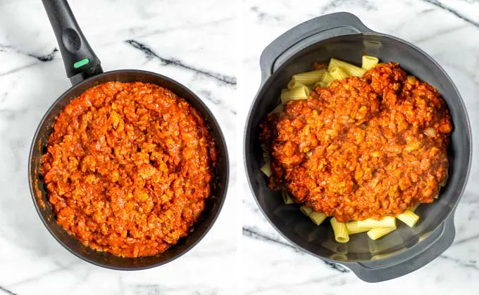 The tomato beef sauce is mixed with precooked pasta in a large bowl.