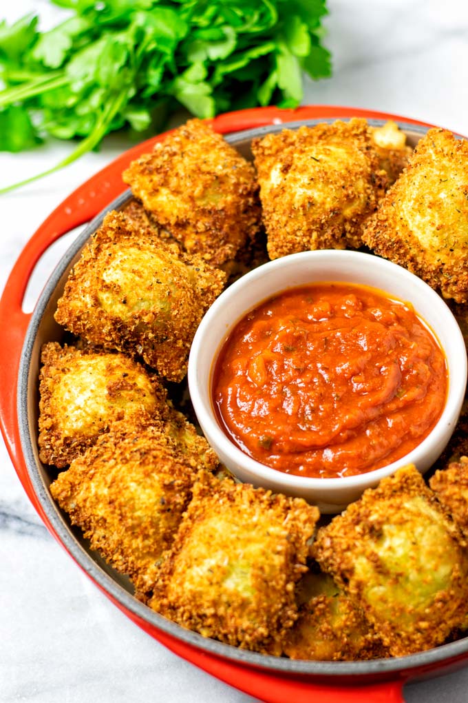 Full serving of Toasted Ravioli with marinara sauce.