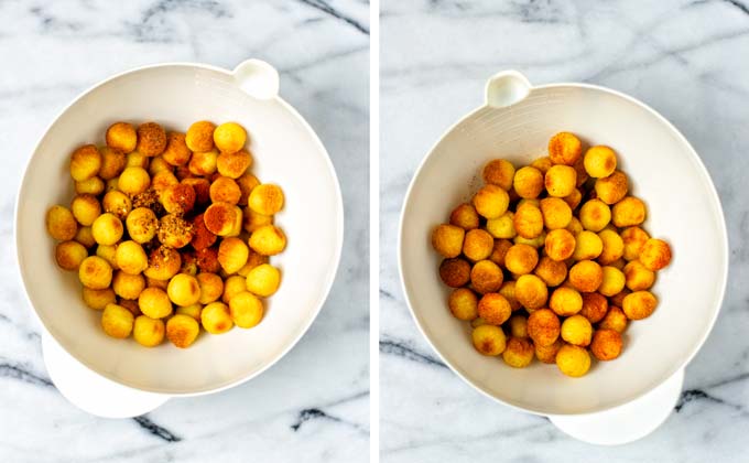 Toasted tater tots are mixed with hot spice mixture in a large mixing bowl.