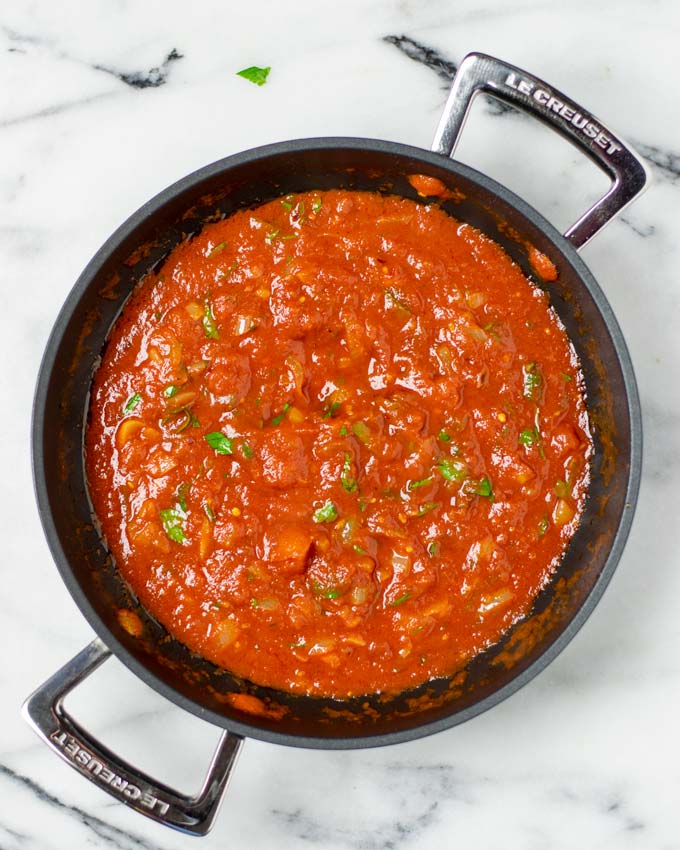 Top view from above on the saucepan with the mixed Arrabbiata Sauce.