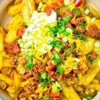 Top view on the Nacho Fries in a large casserole dish.