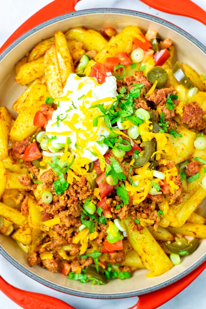 Top view on the Nacho Fries in a large casserole dish. 