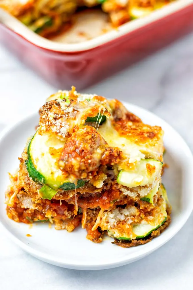 A portion of the Zucchini Parmesan on a small white plate.