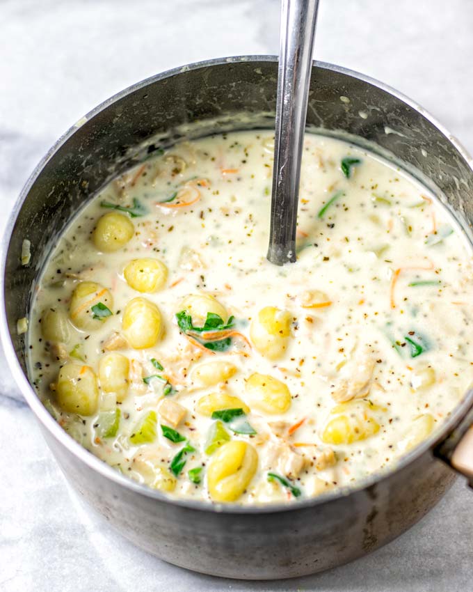 View of the ready Gnocchi Soup in a large saucepan. 