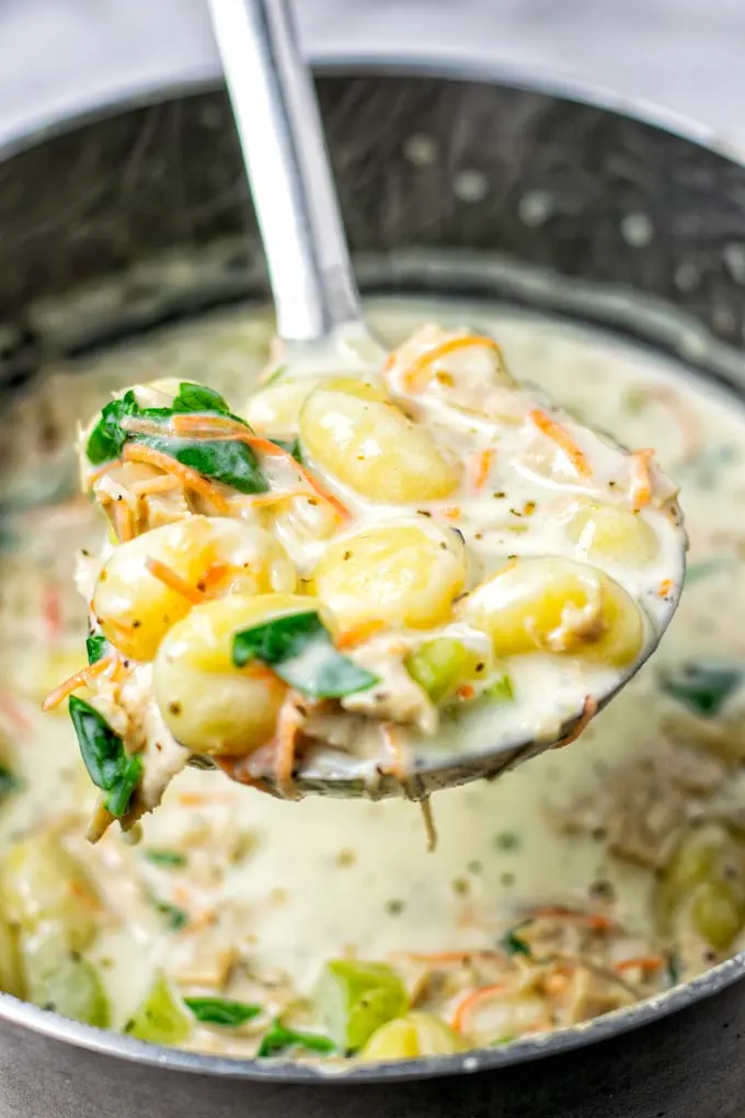 Closeup of a portion of the Gnocchi Soup liften from the pot.