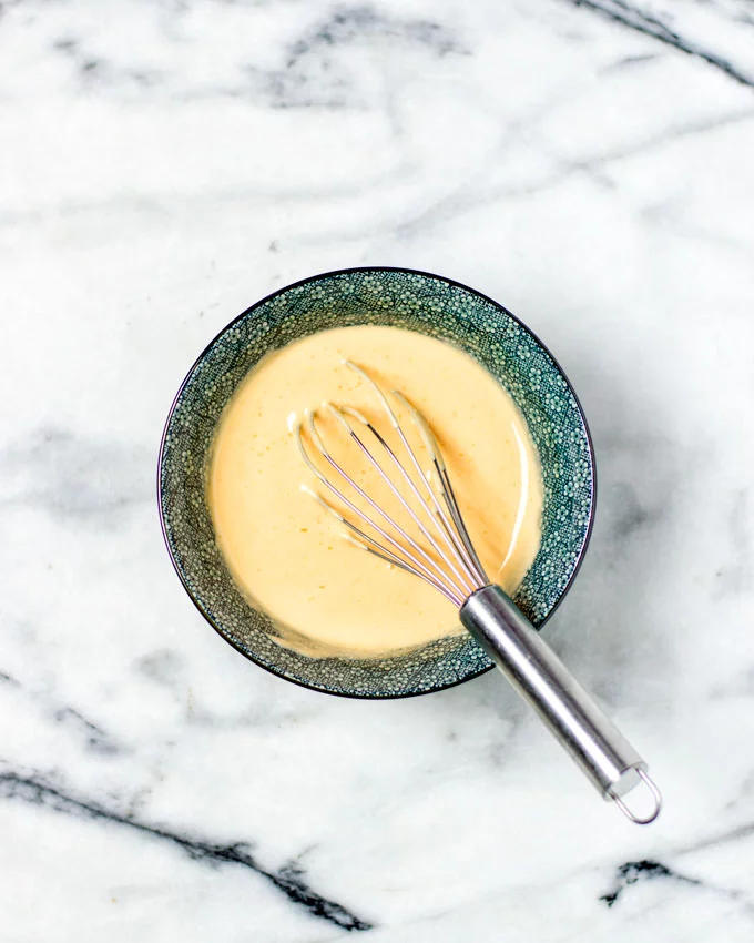 The Marie Rose Sauce is mixed in a bowl with a wire whisk.