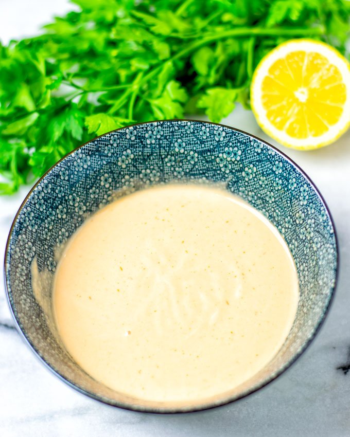 Ready Marie Rose Sauce in a bowl with parsley and a lemon in the background.