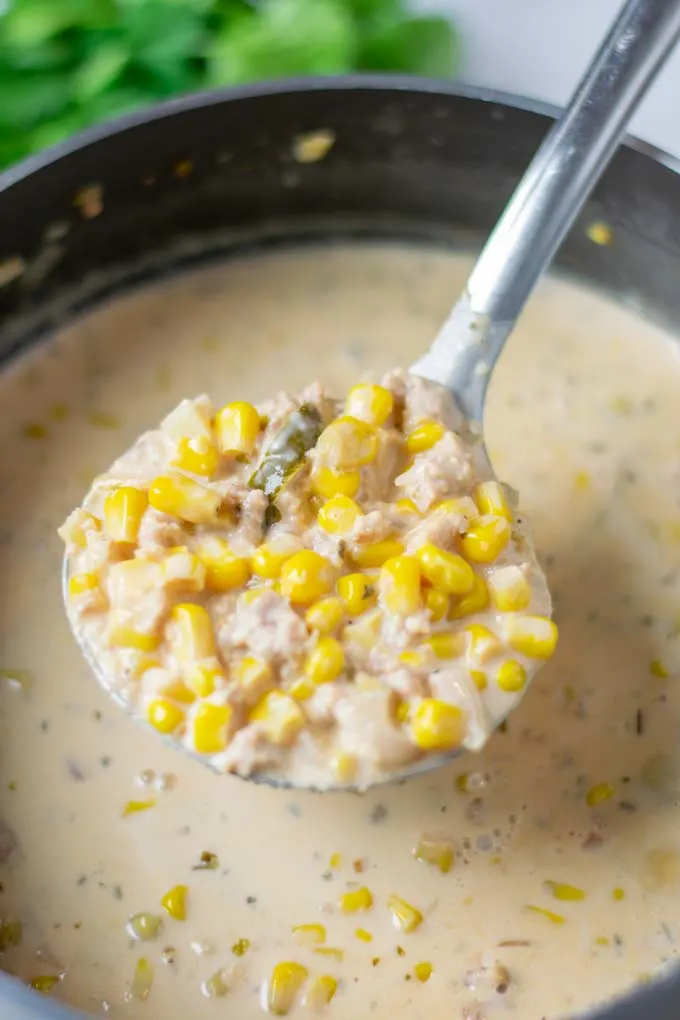 Showing a big spoon of the Corn Soup being lifted from the pot.