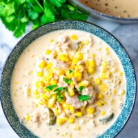 Pot view on a portion of the Corn Soup showing clearly the corn, vegan ground beef, jalapeno slices and creamy liquid.