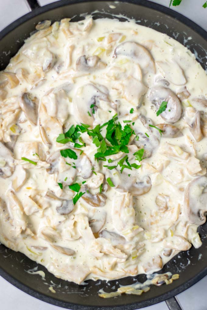 Top view of the Creamy Mushrooms in a pan, with fresh herb garnish.