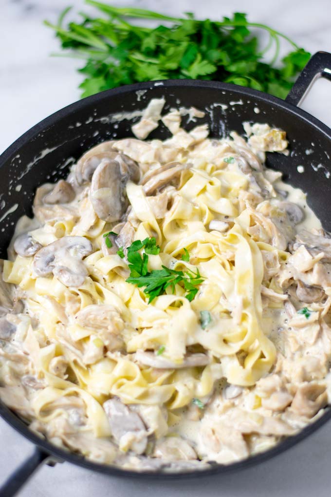 View of the ready Creamy Mushrooms served with fresh pasta.