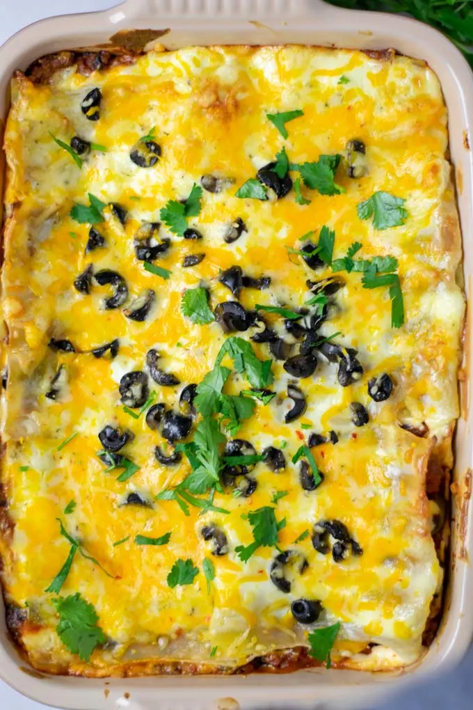 A top view of the Mexican Lasagna with fresh herbs and golden baked cheese.