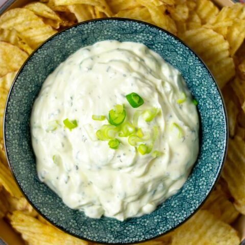 Top view on a bowl with the Potato Chip Dip with fresh scallions.