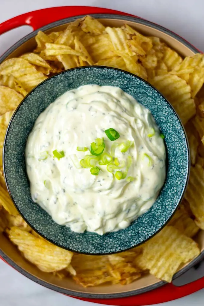 Top view on a bowl with the Potato Chip Dip with fresh scallions.