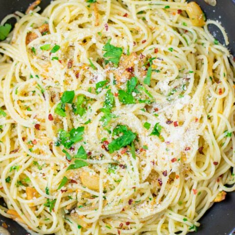 Top view of the Spaghetti aglio e olio with extra vegan Parmesan and herbs.