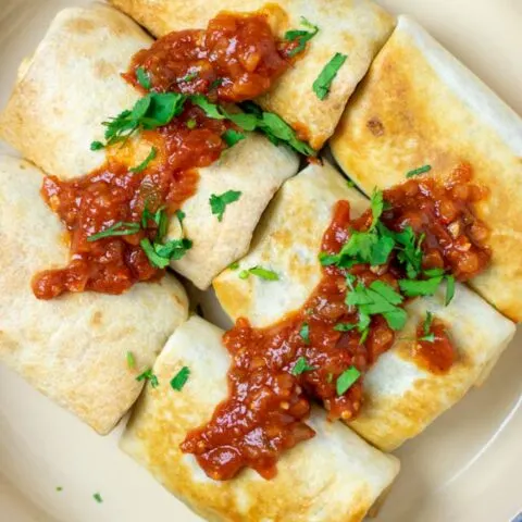 Top view on a large serving dish with ready Chimichangas.