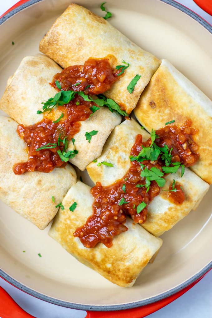 Top view on a large serving dish with ready Chimichangas.