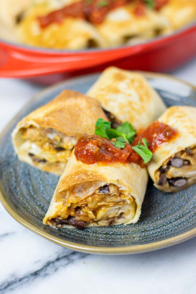 Two Chimichangas cut open on a plate.