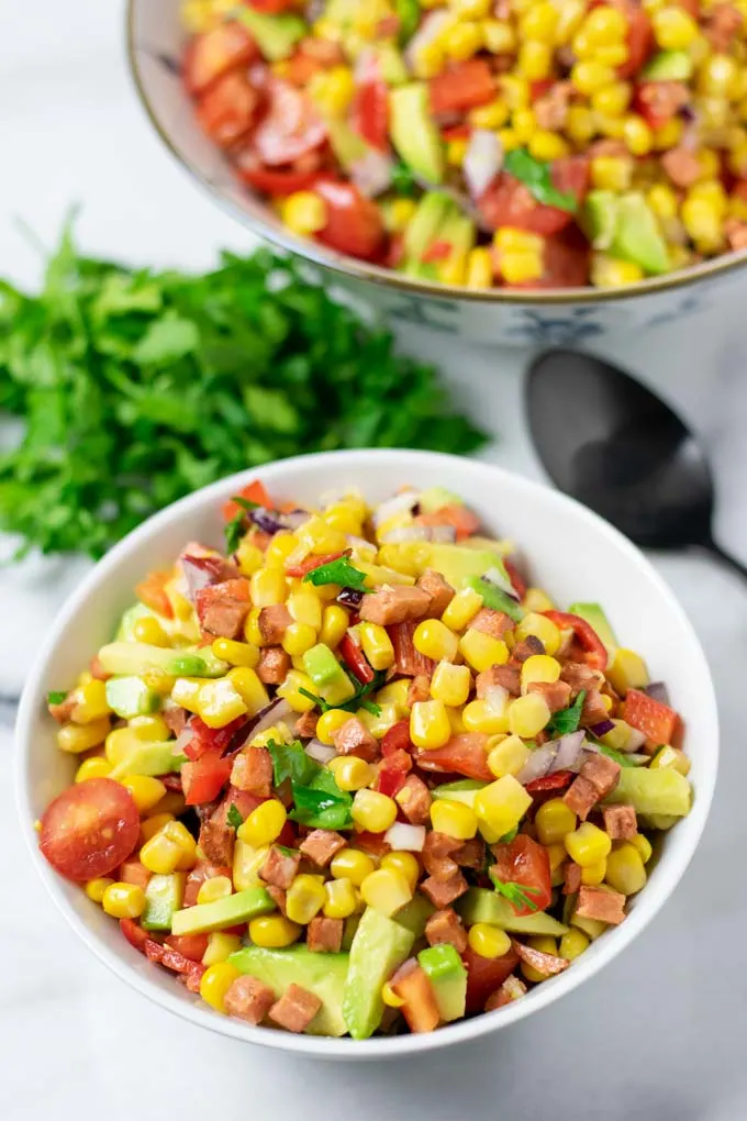 Portion bowl of the Corn Salad with the larger bowl in the background.