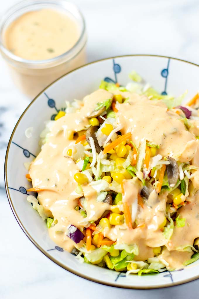 Closeup of a dressed mixed salad in a large bowl.