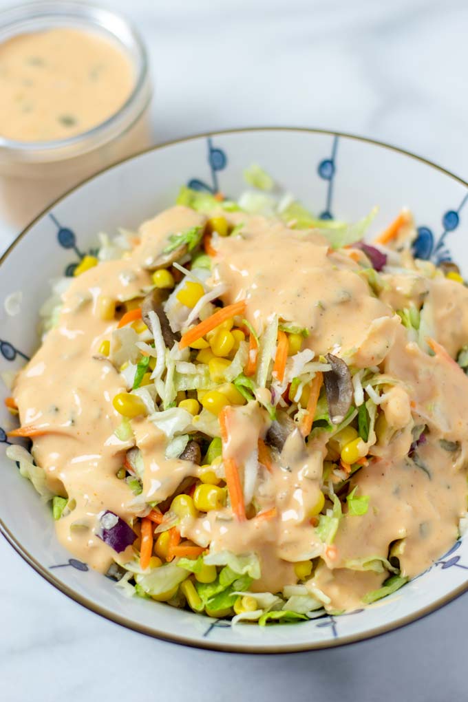 Thousand Island Dressing with a salad in a large bowl.