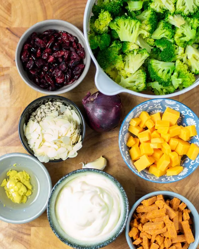 Ingredients for the Broccoli Salad assembled on a wooden board.