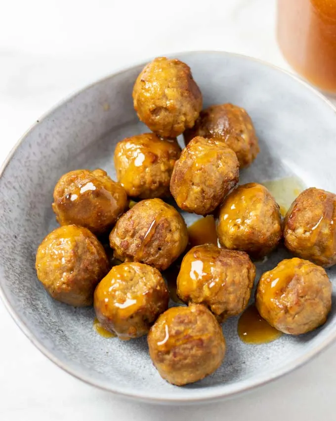 A portion of vegan meatballs covered in Hawaiian Sauce. 