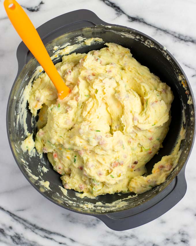 Top view of a large mixing bowl with the loaded Mashed Potatoes.