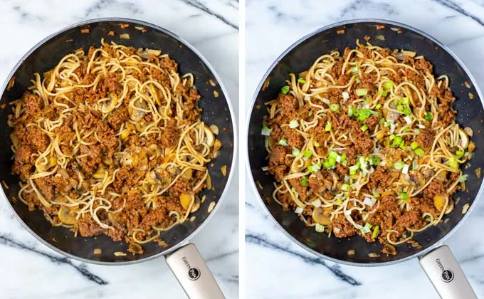 Side by side view of the Mushroom Noodles in a large pan with fresh scallions on top.