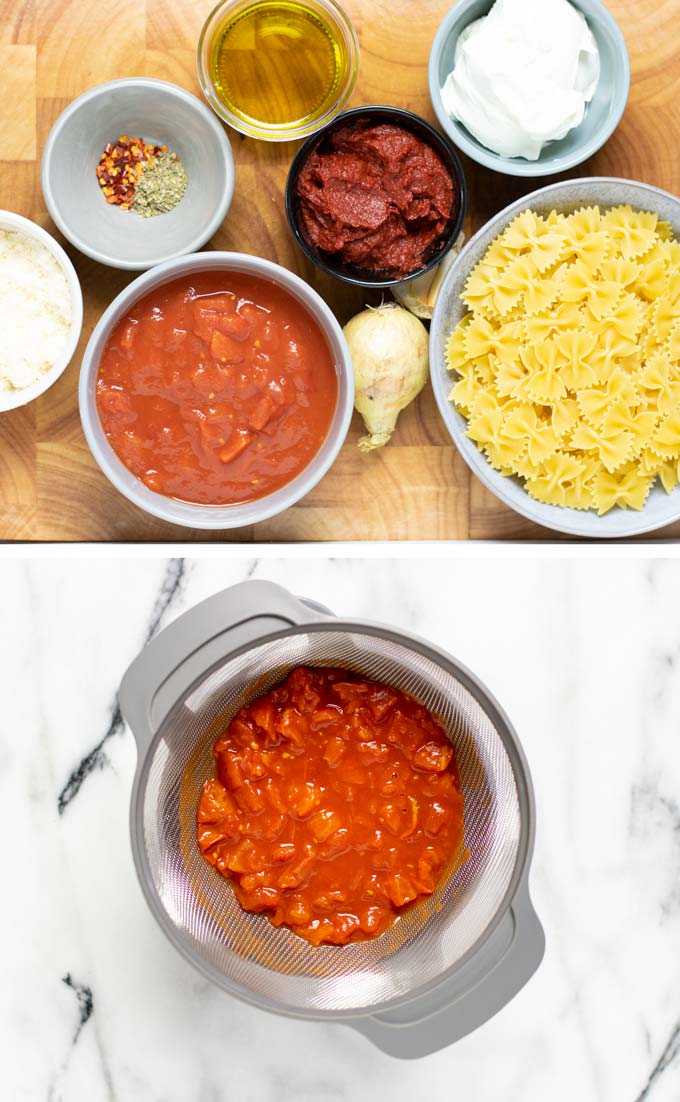 Ingredients needed to make this Creamy Tomato Pasta assembled on a wooden board.