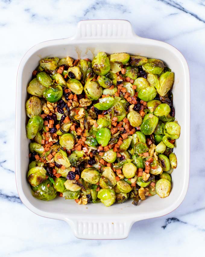 The Crispy Brussels Sprouts are transferred to a casserole dish.
