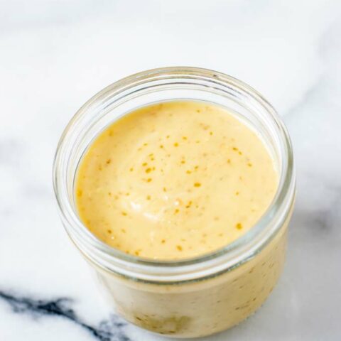 A glass jar with the Roasted Sesame Dressing.