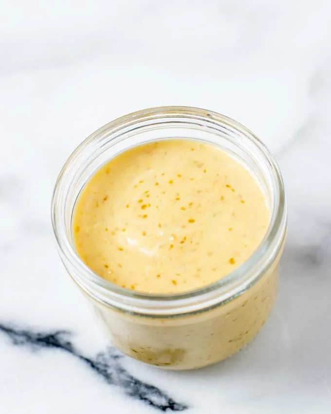 A glass jar with the Roasted Sesame Dressing.