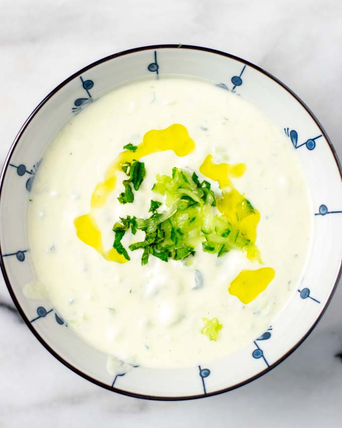 Top view of a bowl of the Tzatziki Sauce with olive oil drizzle.