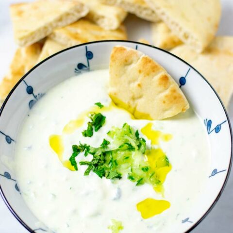 Bowl of the Tzatziki Sauce with toasted pita bread.