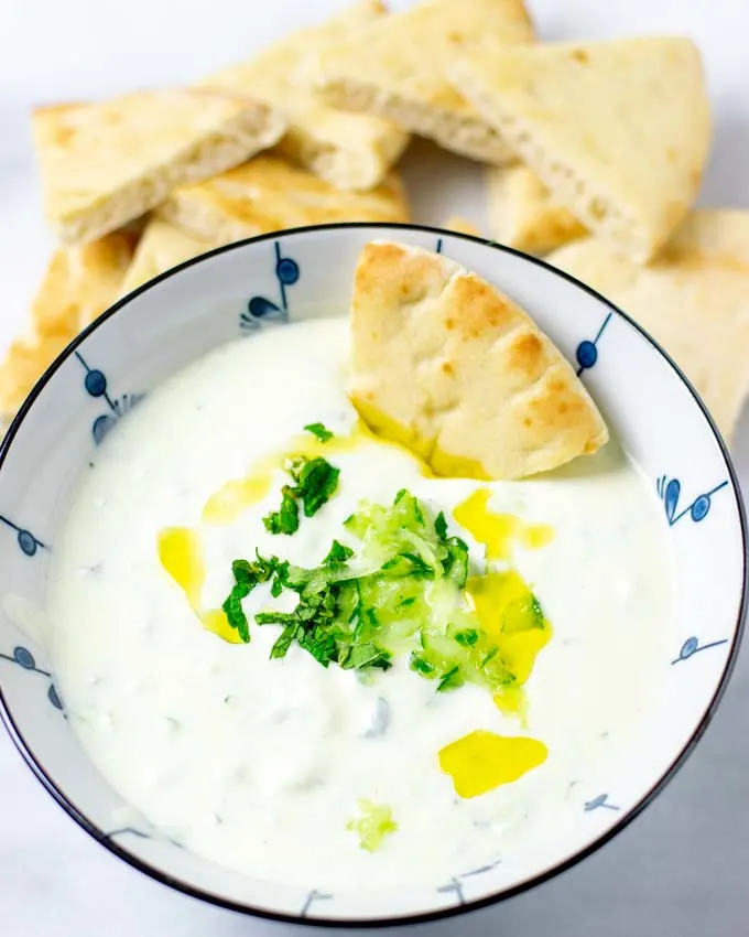 Bowl of the Tzatziki Sauce with toasted pita bread.