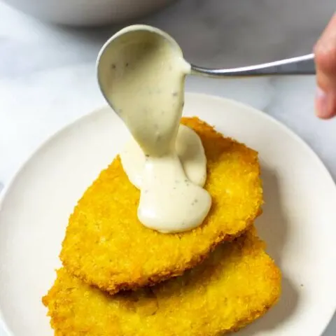 Country Gravy is poured over a stack of vegan chicken steaks.