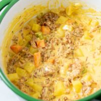 Closeup of the Cheeseburger Soup in a large pot.